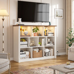 In the center of the living room stands a white storage cabinet, with a television hanging directly above it. The cabinet is uniformly white, with a smooth surface as reflective as a mirror, which reflects the soft sunlight streaming in from the window, casting faint shadows on the floor.