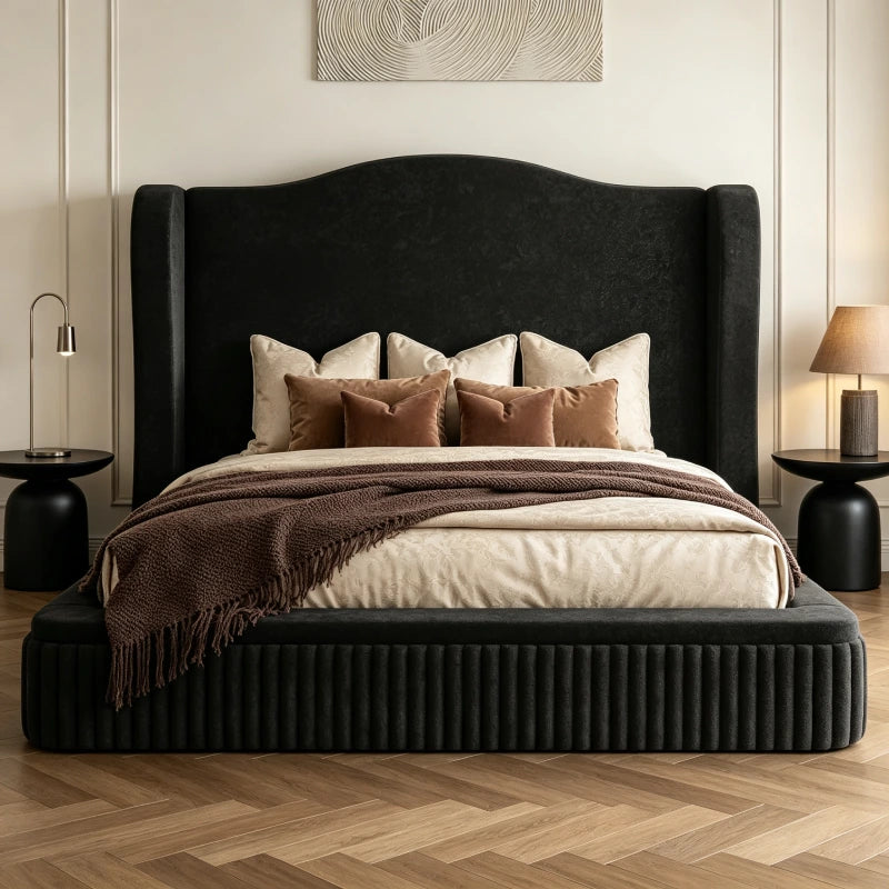 Make a bold statement with a black upholstered bed frame featuring a dramatic wingback headboard and plush vertical corduroy footboard.